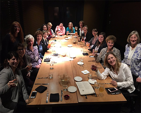 group of women from the GioWomen Meeting seated around a long table